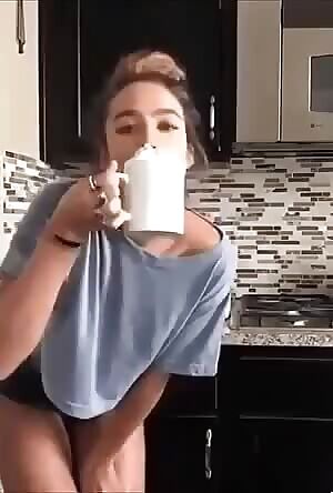Drinking coffee and shaking her butt