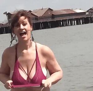signaling to sailors with her massive jugs