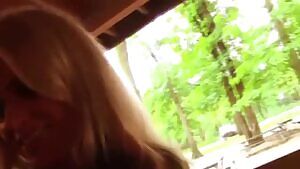 She sits down on his dick and fucks him in public.