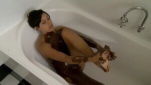 Rubbing chocolate all over her feet