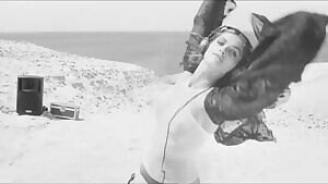 Elisa Sednauoi dancing in the dunes