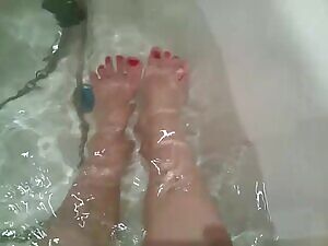 I play with my feet in the water
