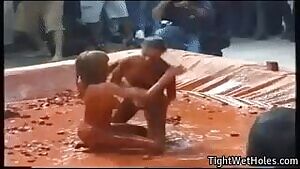 Two Topless Girls Wrestle in Clay