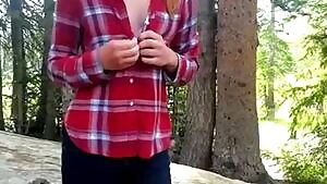 Gingerly removing her clothes in the woods