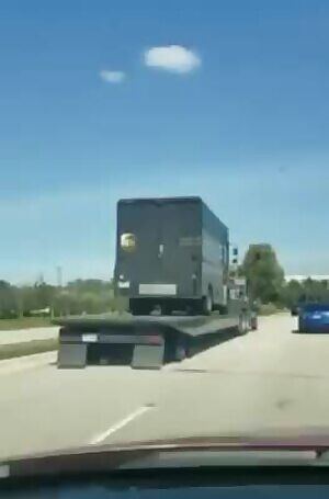 The UPS van which was shot up by police while the hostage was still inside .