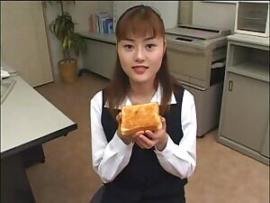Office worker eats a slice of toast