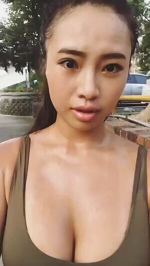 busty girl wiping her forehead