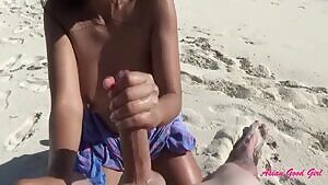 asian good girl jerks a long dong on the beach
