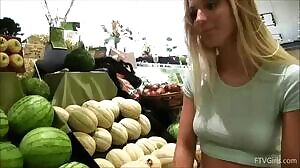 Playing with her melons in the supermarket