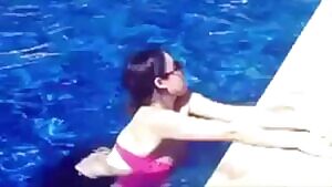 Liz Gillies posing in a pool