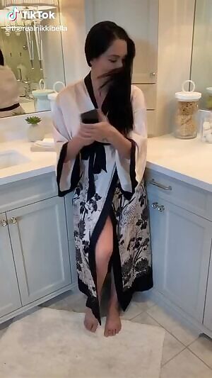 Nikki Bella trying to cover up her big boobs