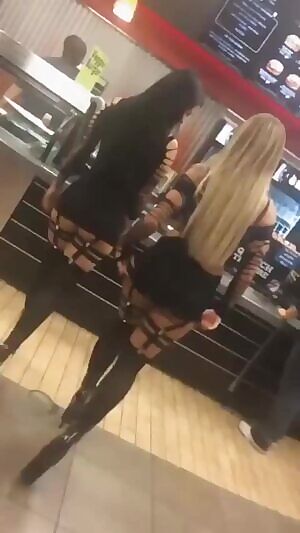 Blonde and brunette with tattoos shake their asses in the vegetarian cafeteria