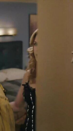 While on vacation, your stepmom Jenna Fischer texts you to come to her room to help her with something. She answers the door like this. What's happening next?