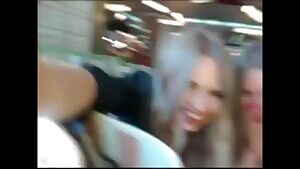 Two girls taking off their clothes in public cafe while being watched