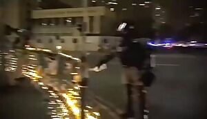 Hong Kong cop pours water to put out candles commemorating student who just passed away following fall near police operation