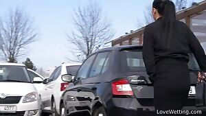 Vanda pissing in a parking lot