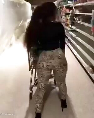 Girl with big tits and jiggling ass pushes a shoppingcart